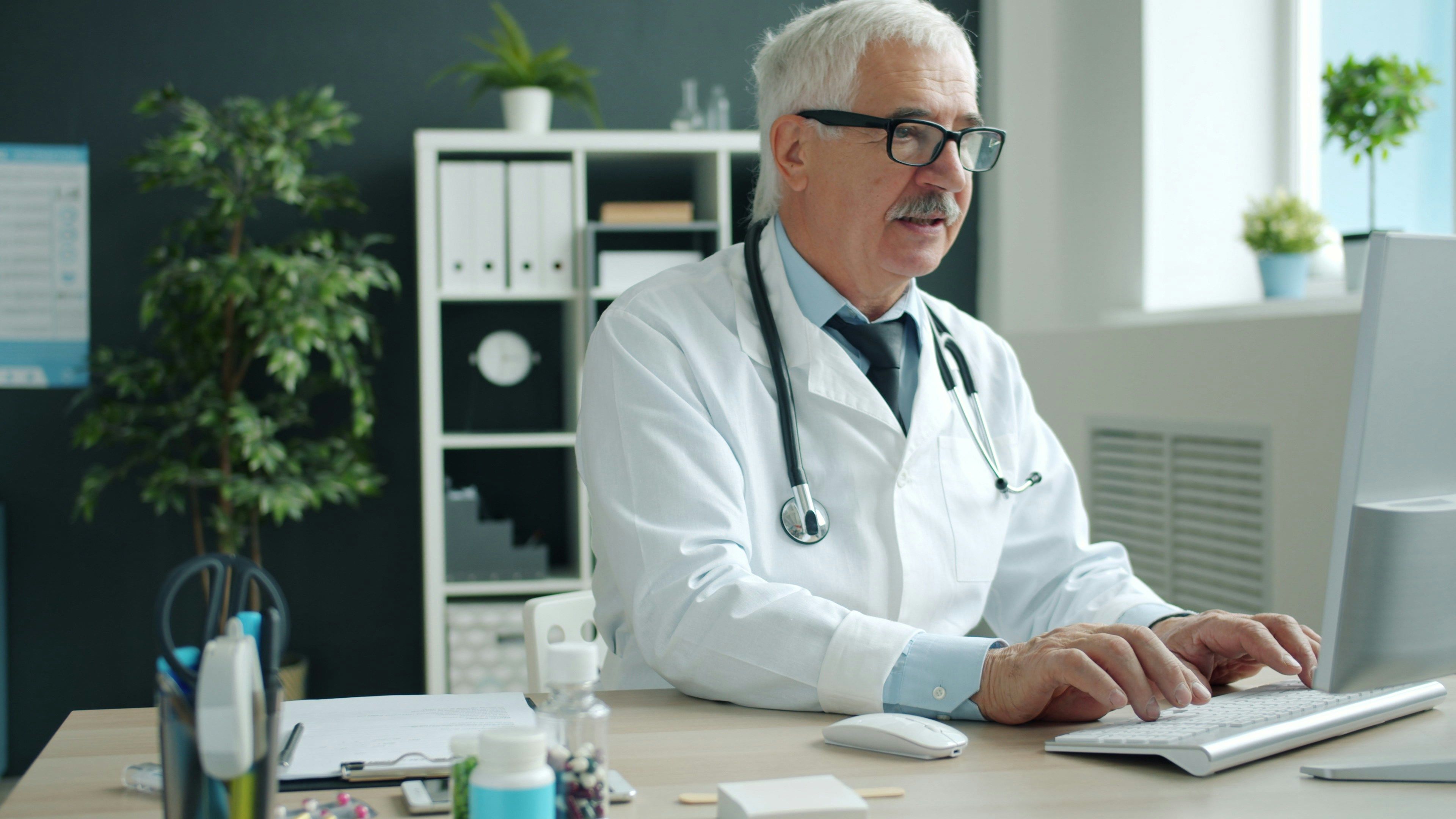 doctor reviewing electronic health record on a computer in a modern hospital